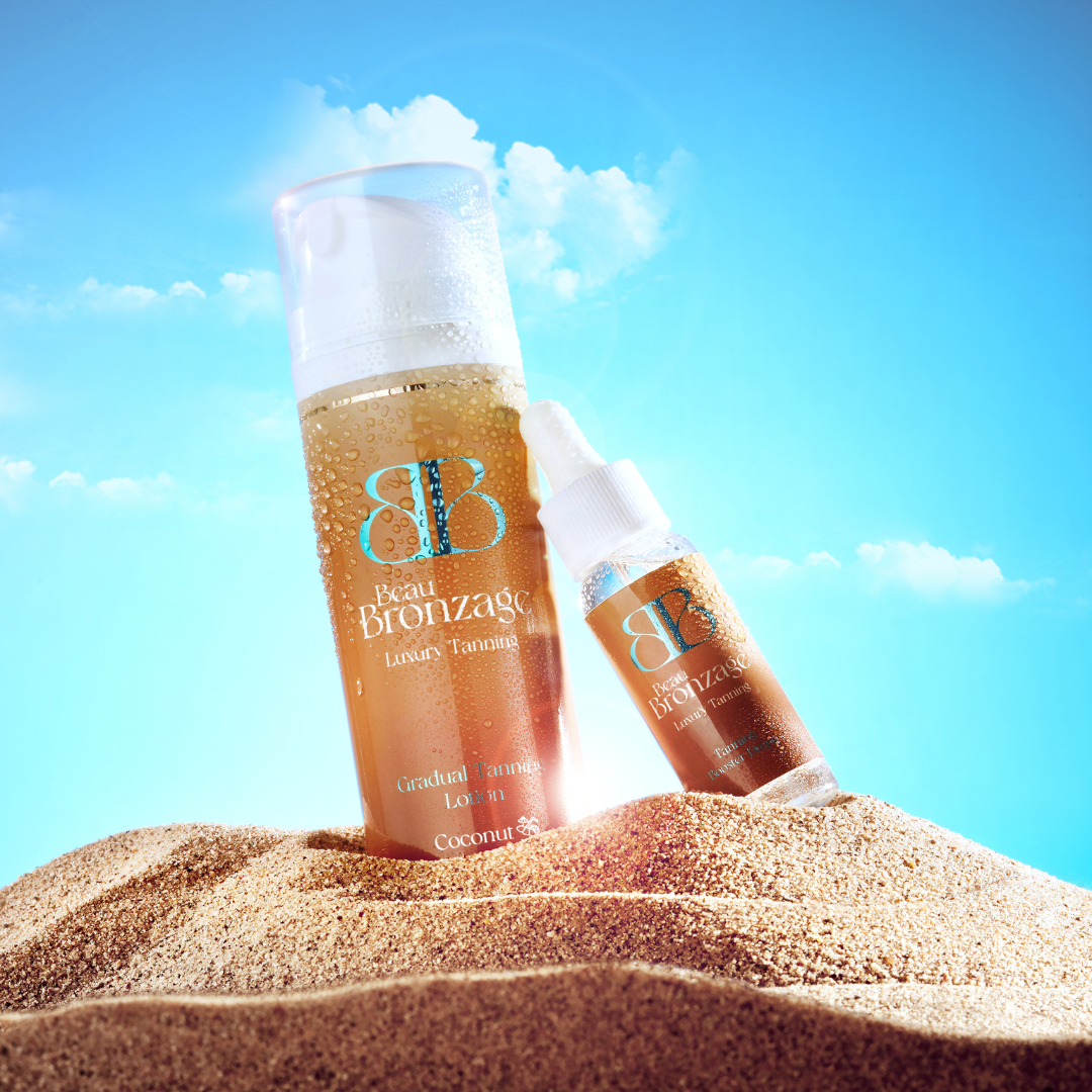 Beau Bronzage Every Day Gradual Tanning Lotion with a bottle of bronzing drops, rested on a sand dune against a brilliant blue sky